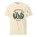 Ivory Comfort Colors tee, flat front view, with a round red and green 'I Survived the Stairs' badge showing Amicalola Falls and the trail staircase through pine trees